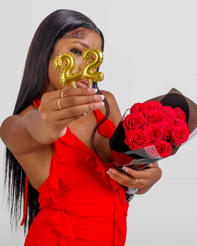 22nd birthday portrait with gold balloon candles and roses